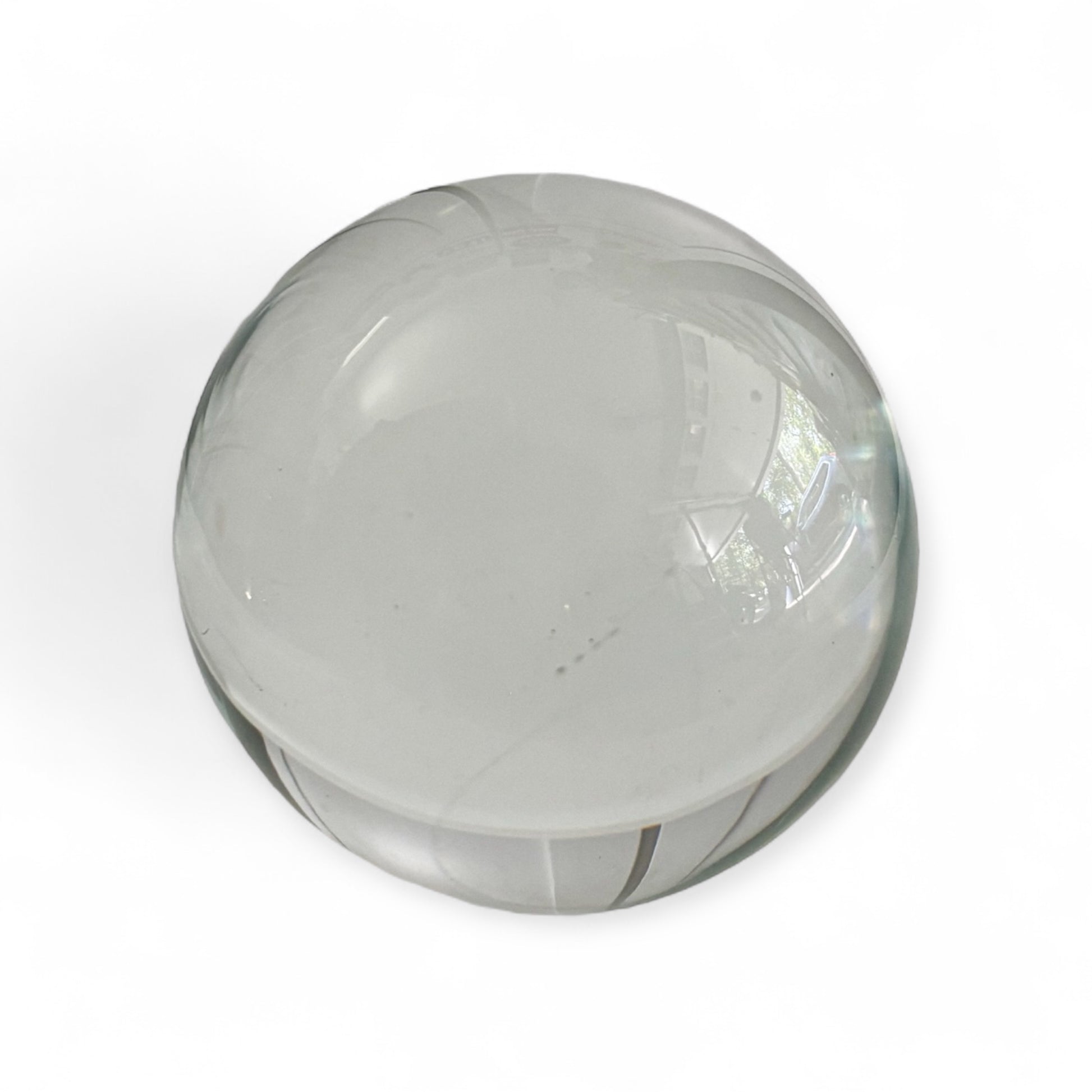Close-up of a clear glass gazing ball showing smooth transparent surface