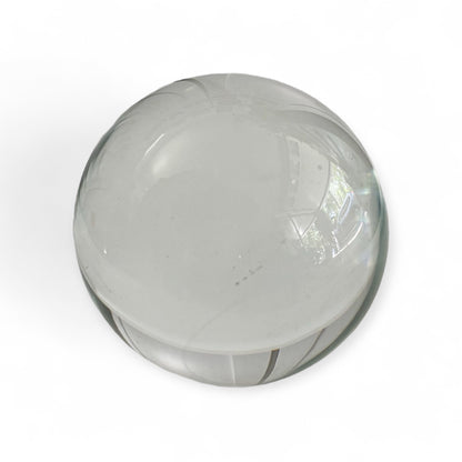 Close-up of a clear glass gazing ball showing smooth transparent surface