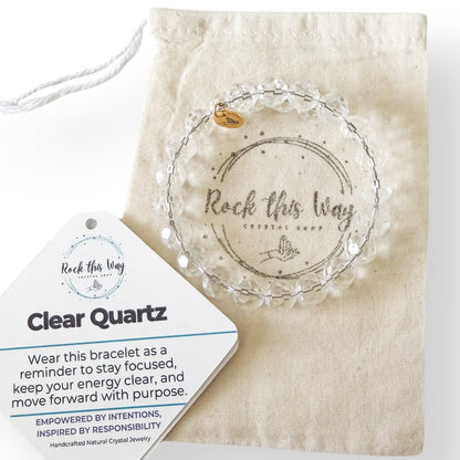 Clear Quartz 10mm micro-faceted bracelet displayed with cotton pouch and meaning card.