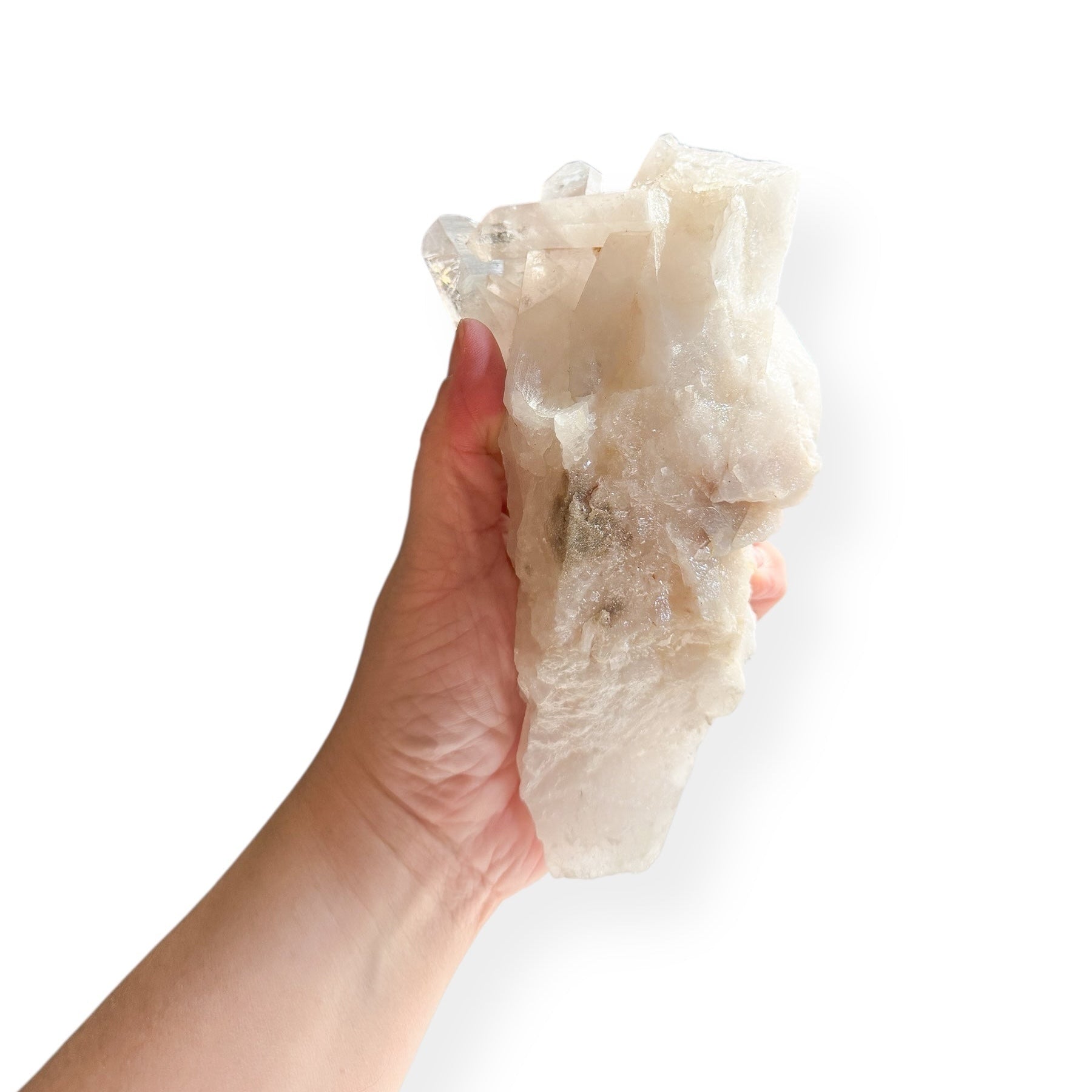 Hand holding Clear Quartz Point Cluster to show size and clarity