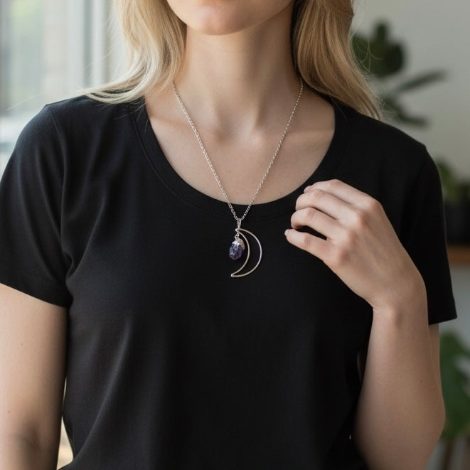 AI model wearing a silver plated crescent moon necklace with a raw amethyst crystal on an 18.5 inch stainless steel chain