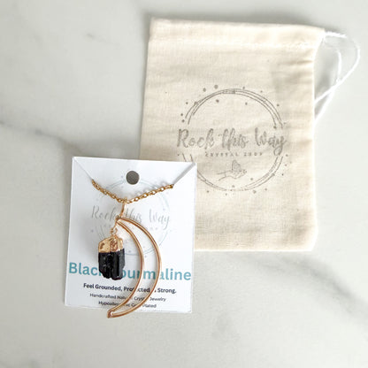 Gold plated crescent moon with black tourmaline pendant necklace displayed on Rock This Way Crystal Shop packaging, ready for gifting.