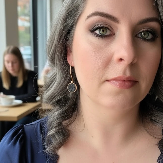 Dark gray round drusy drop earrings worn on ear with gold filled hooks for everyday style