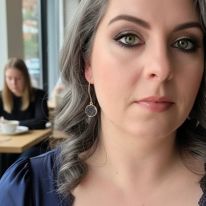 Dark gray round drusy drop earrings worn on ear with gold filled hooks for everyday style