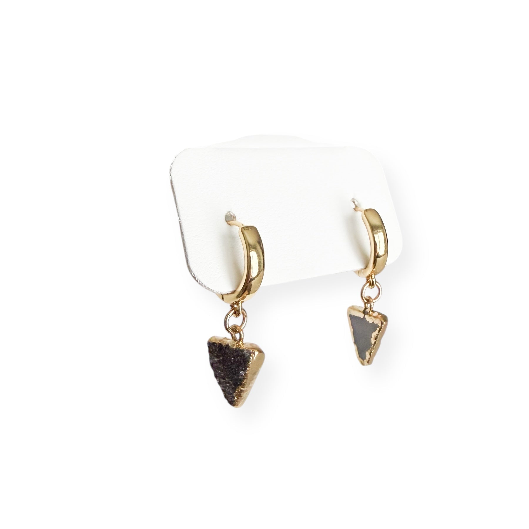 Close-up detail of dark triangle drusy crystal charm showing natural sparkle and texture on gold filled huggie earrings.