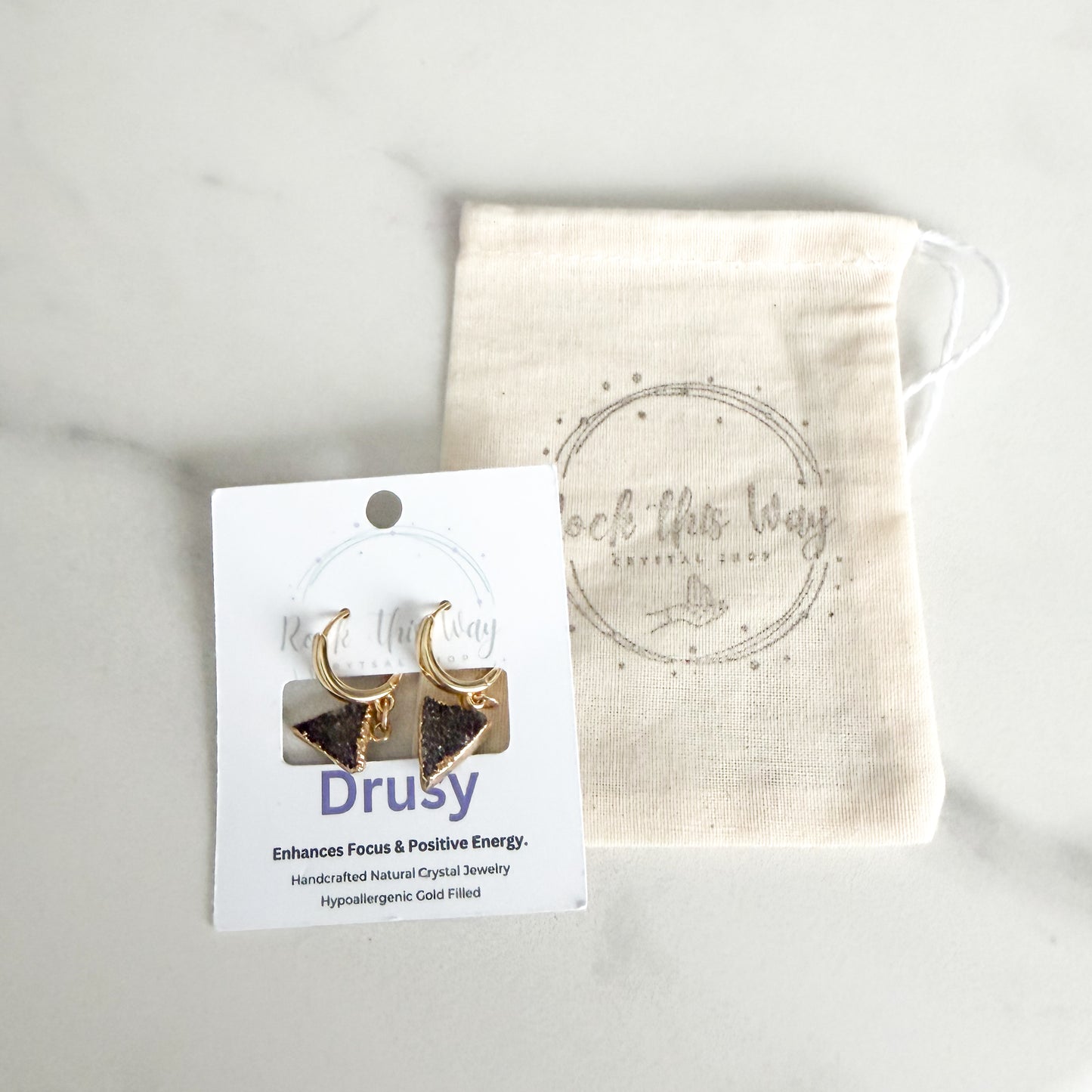 Dark triangle drusy huggie earrings packaged on Rock This Way Crystal Shop branded card, ready for gifting.