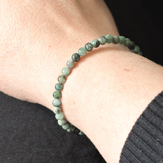 Emerald wrap bracelet worn on wrist, showing its flexible and adjustable fit.