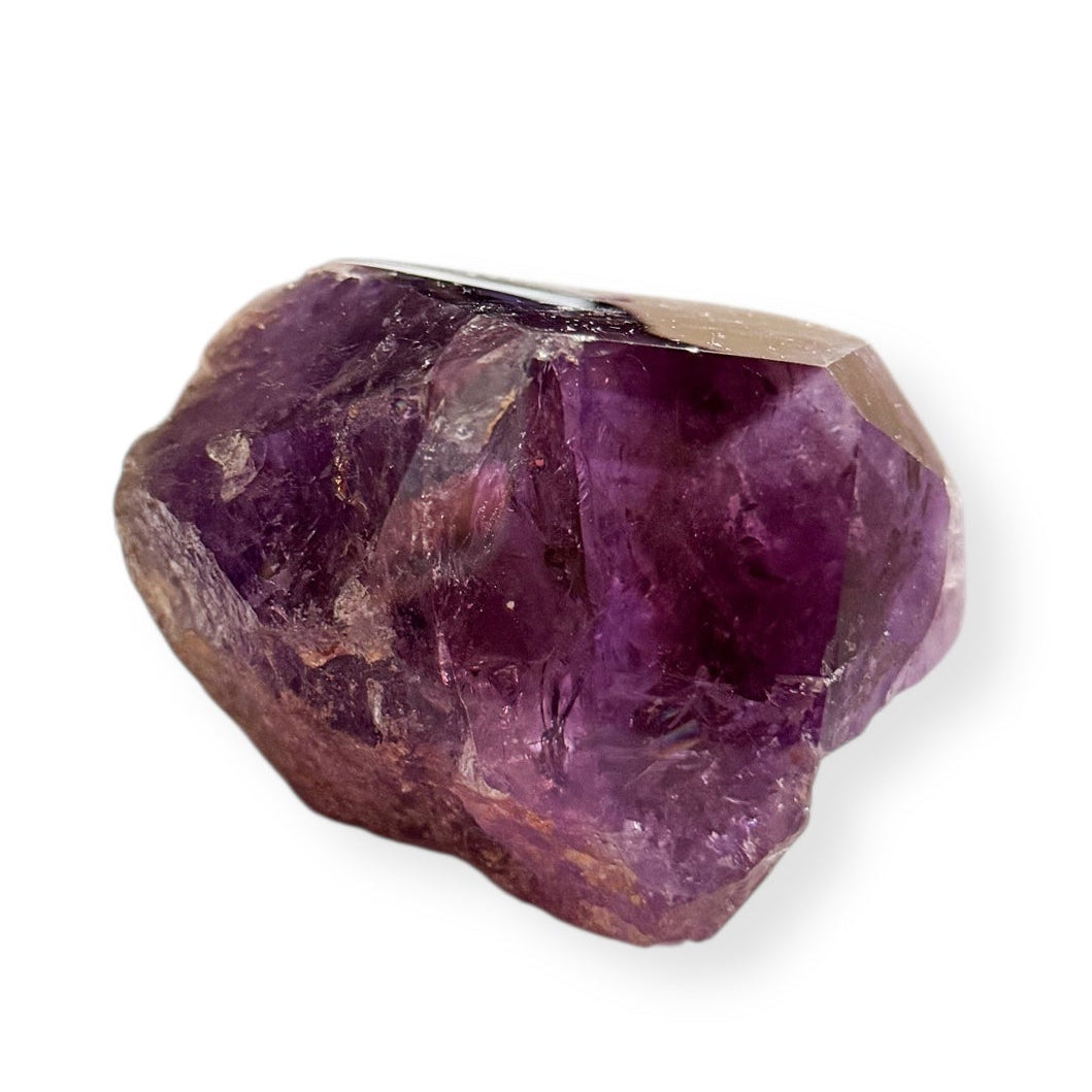 Raw back surface of natural amethyst point with purple tones