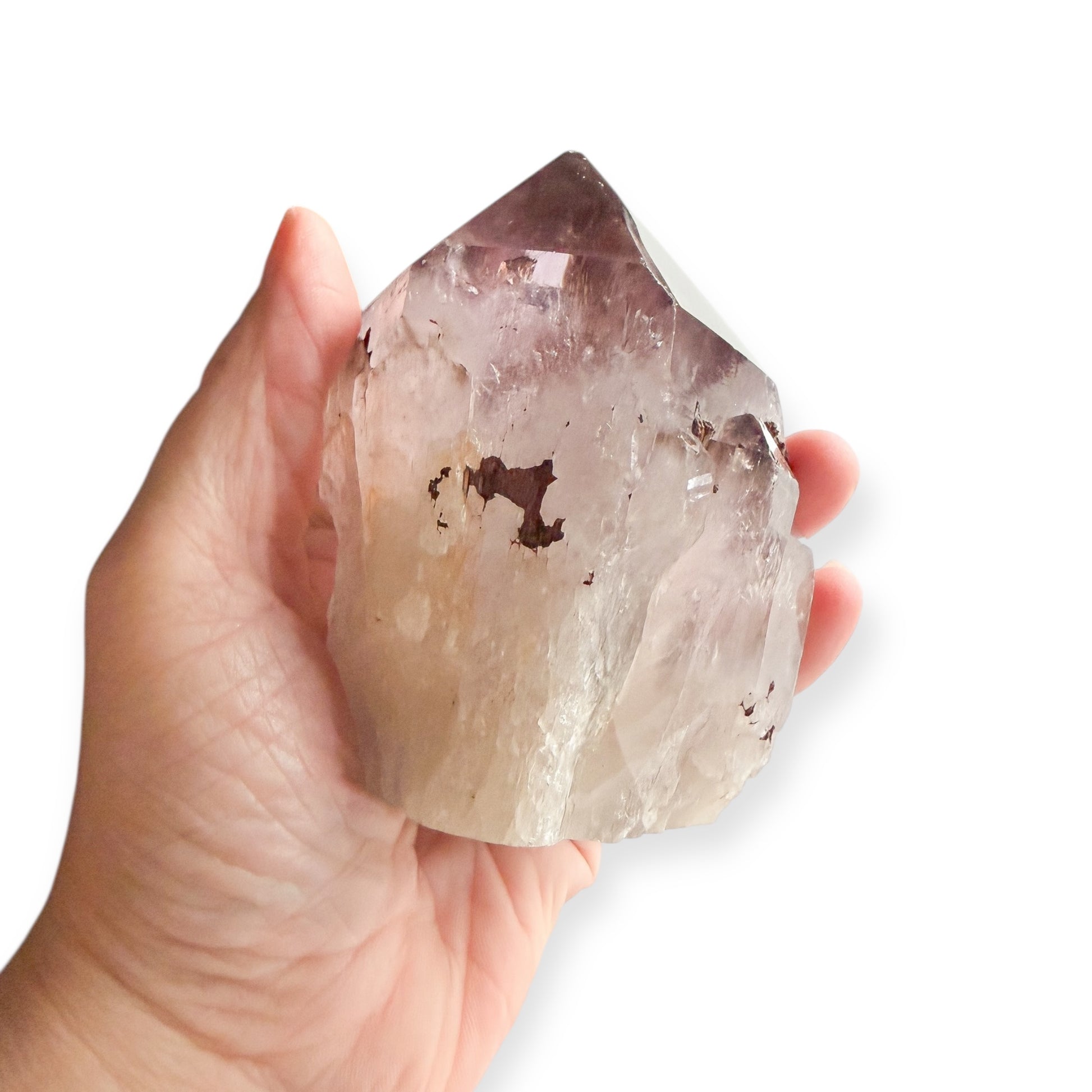 Large amethyst polished point shown in hand for size reference