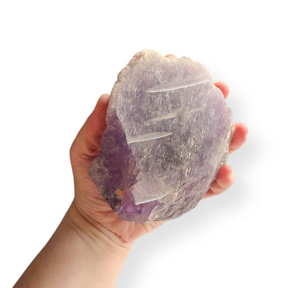 Amethyst crystal held in hand to show size