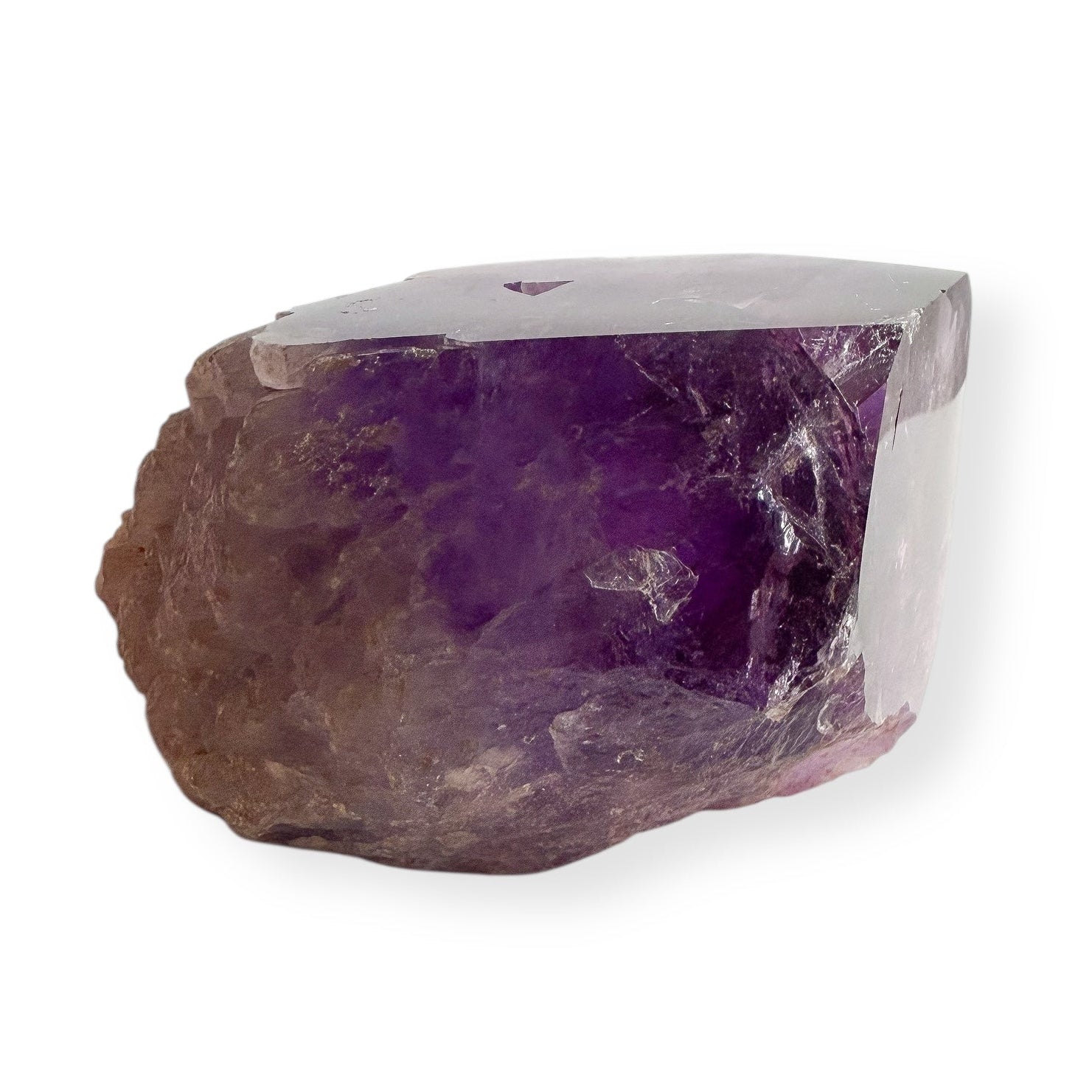 Polished face of raw natural amethyst showing clarity and color