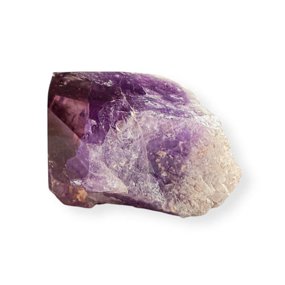 Side view of large raw amethyst point with natural texture