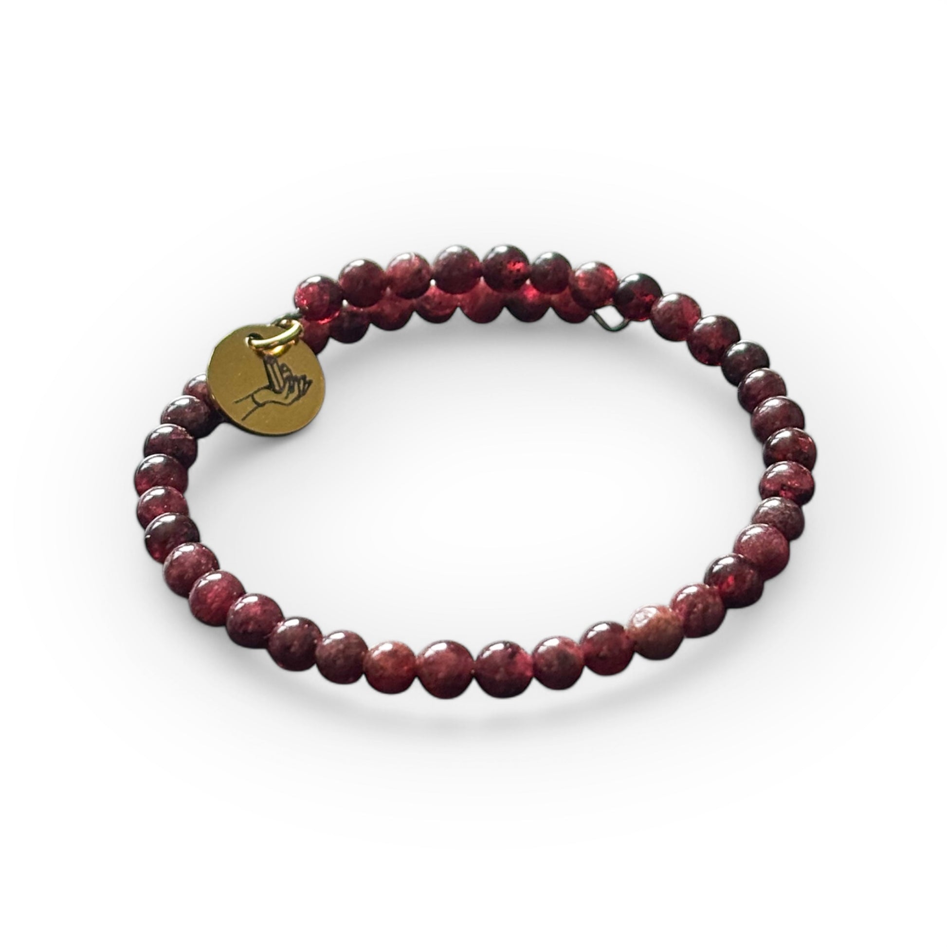 Close-up of Garnet wrap bracelet showcasing its deep red, polished round beads.