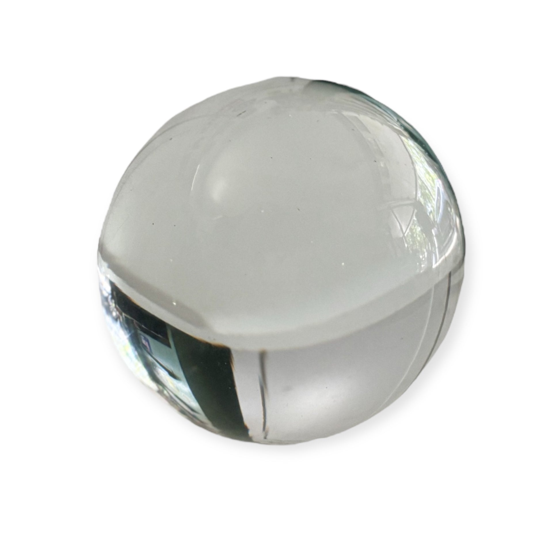 Clear gazing ball reflecting natural light and surroundings