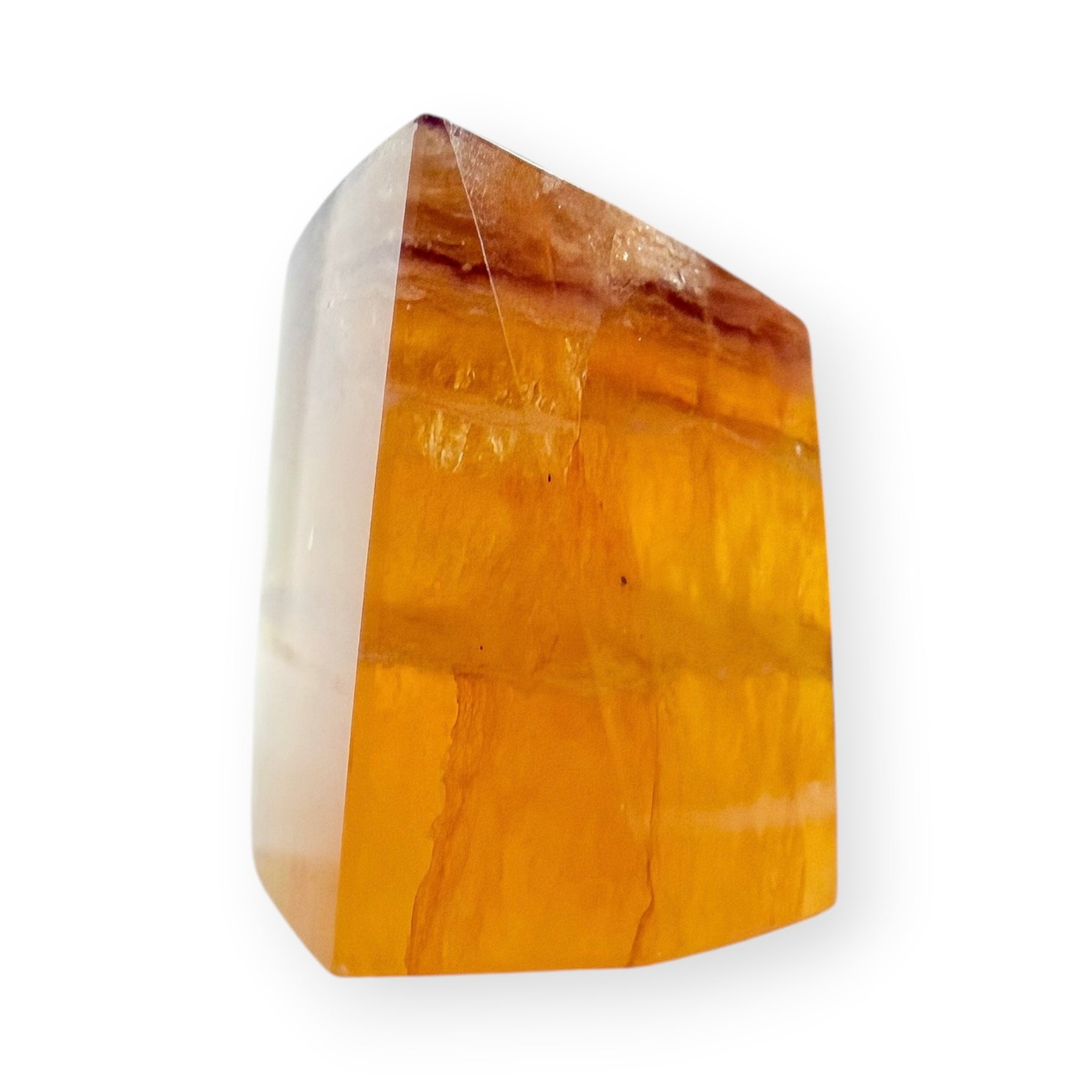 Golden Fluorite freeform with warm honey-colored translucency, polished surfaces, and natural amber banding.