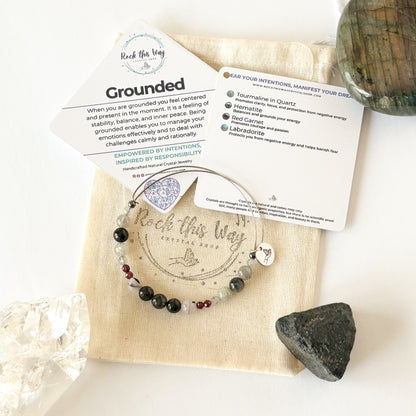 Grounded crystal bracelet styled with neutral outfit, showing bracelet stack and natural colors