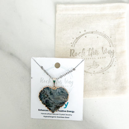 Silver plated heart drusy pendant necklace displayed on Rock This Way Crystal Shop packaging with included polishing cloth.