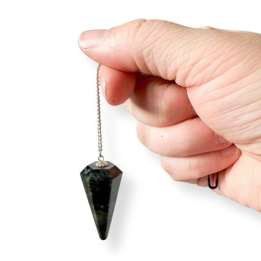 Kambaba Jasper pendulum used as a divination tool, featuring deep green natural stone with stainless steel chain