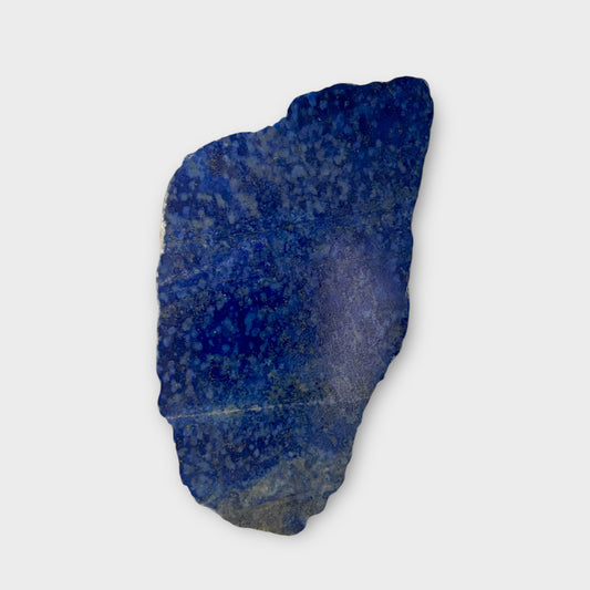 Polished Lapis Lazuli crystal slab showing vibrant blue and light speckling