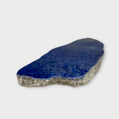 Side view of polished Lapis Lazuli slab showing uneven edges and depth