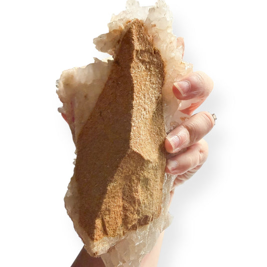 Back view of Large Quartz Cluster showing natural matrix base held in hand