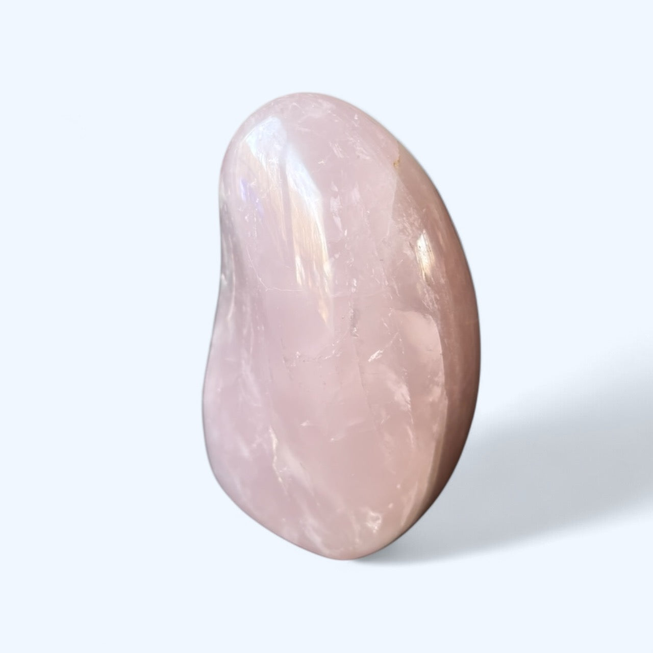 Side view of Lavender Rose Quartz crystal with polished curves and calming hue