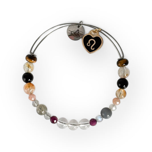 Leo Crystal Charm Bracelet with a black charm, featuring Clear Quartz, Ruby, Labradorite, Sunstone, Citrine, Black Onyx, and Tiger’s Eye for courage and personal power.