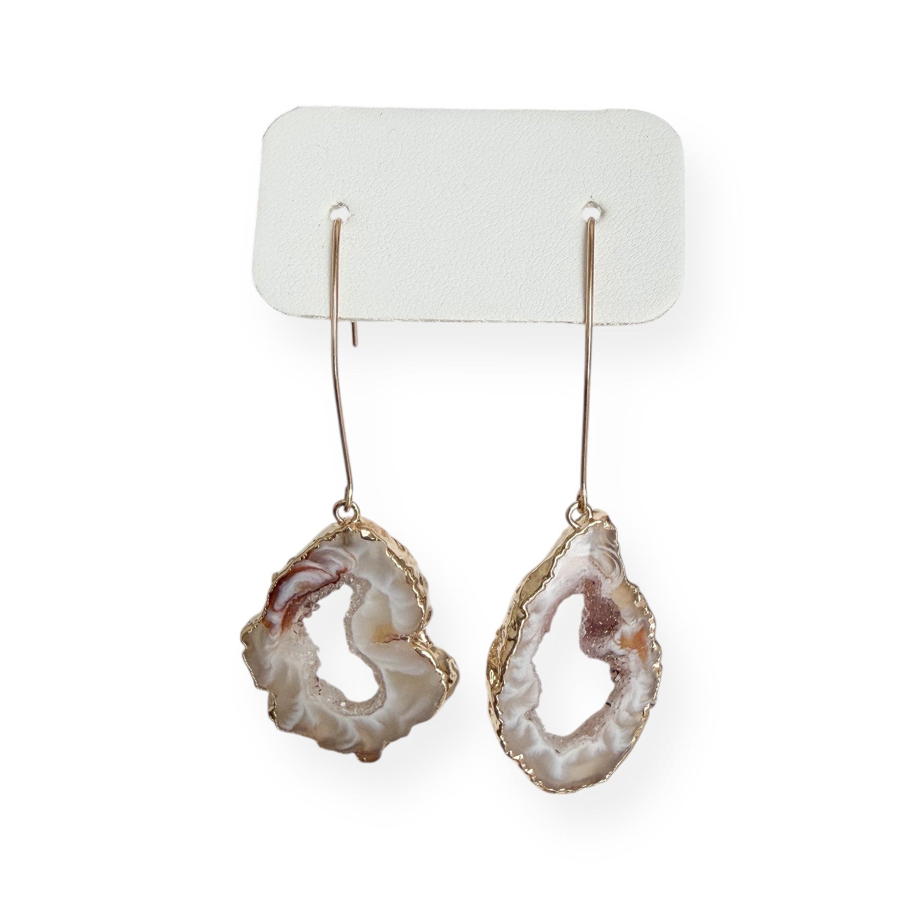 Close up of light agate slice geode earrings showing natural crystal layers and gold filled edging
