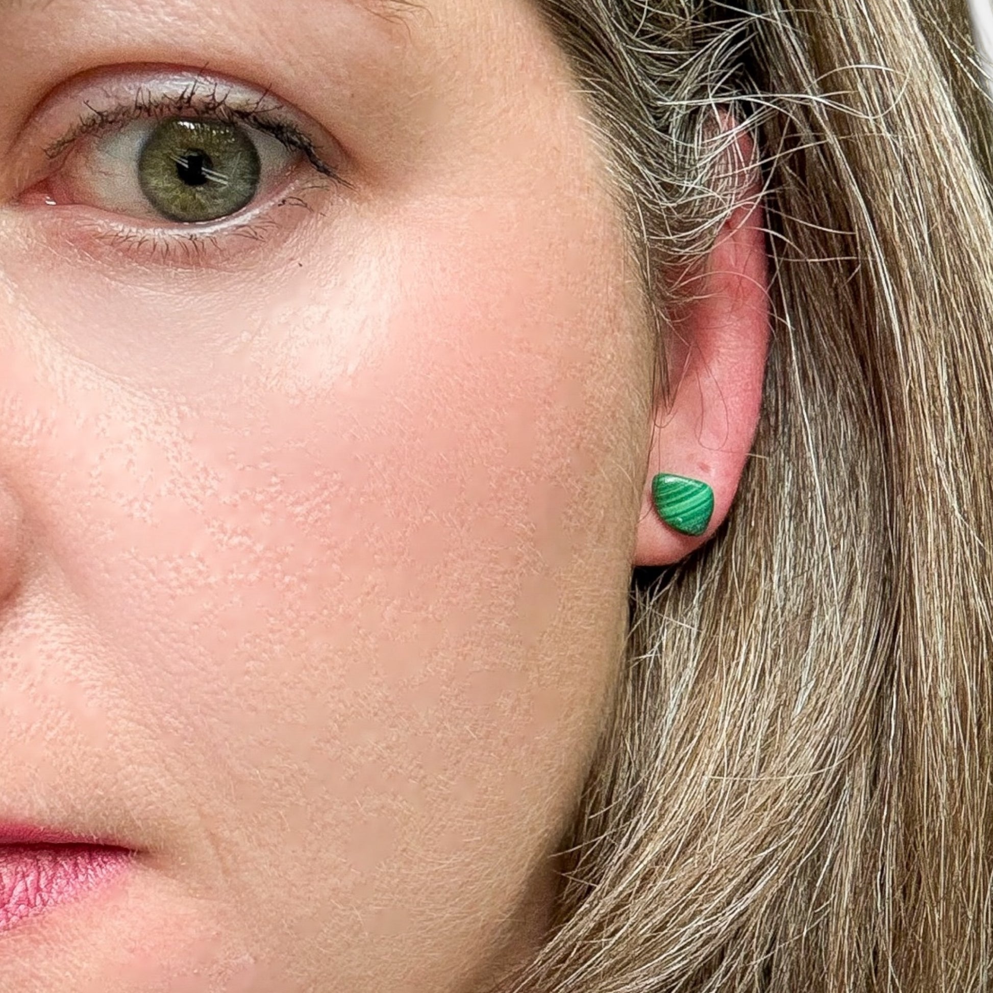 Front view of tumbled Malachite stud earrings on hypoallergenic stainless steel posts