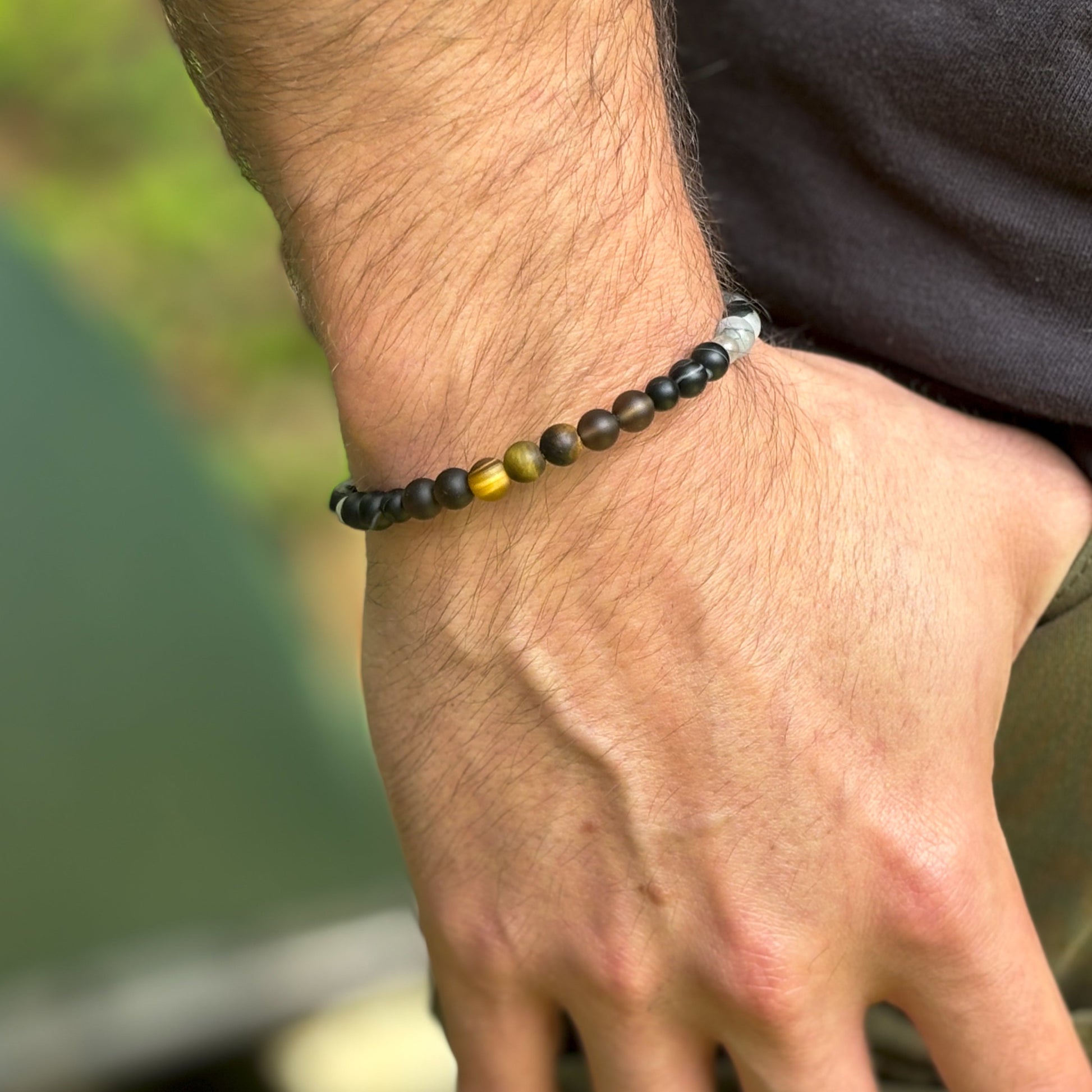 Men’s Protection Bracelet worn on wrist showing matte crystal beads and sleek fit