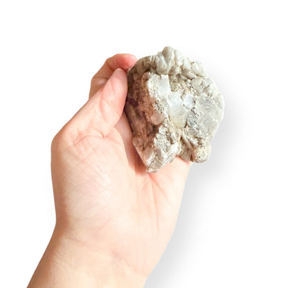 Muscovite Mica crystal cluster shown in hand for scale
