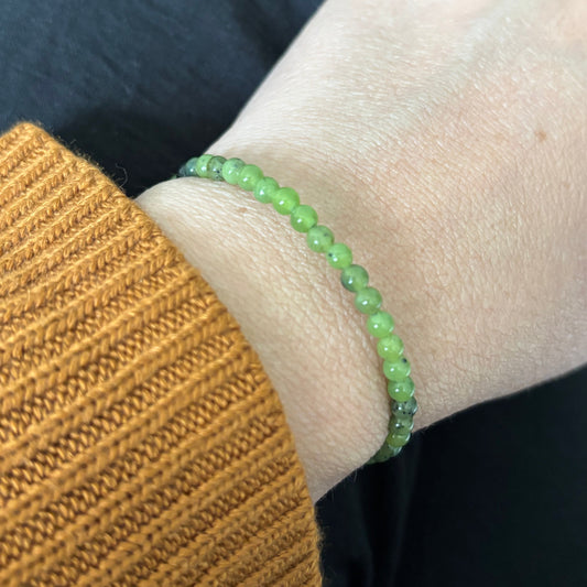 Nephrite Jade bracelet wrapped on wrist with neutral-toned outfit