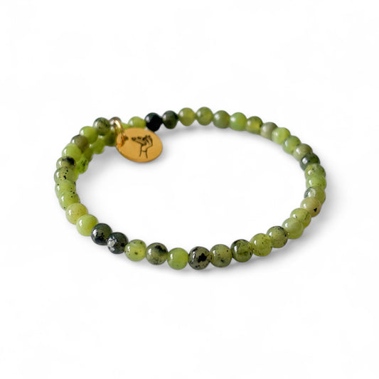 Close-up of Nephrite Jade beads showing earthy green tones and subtle shine