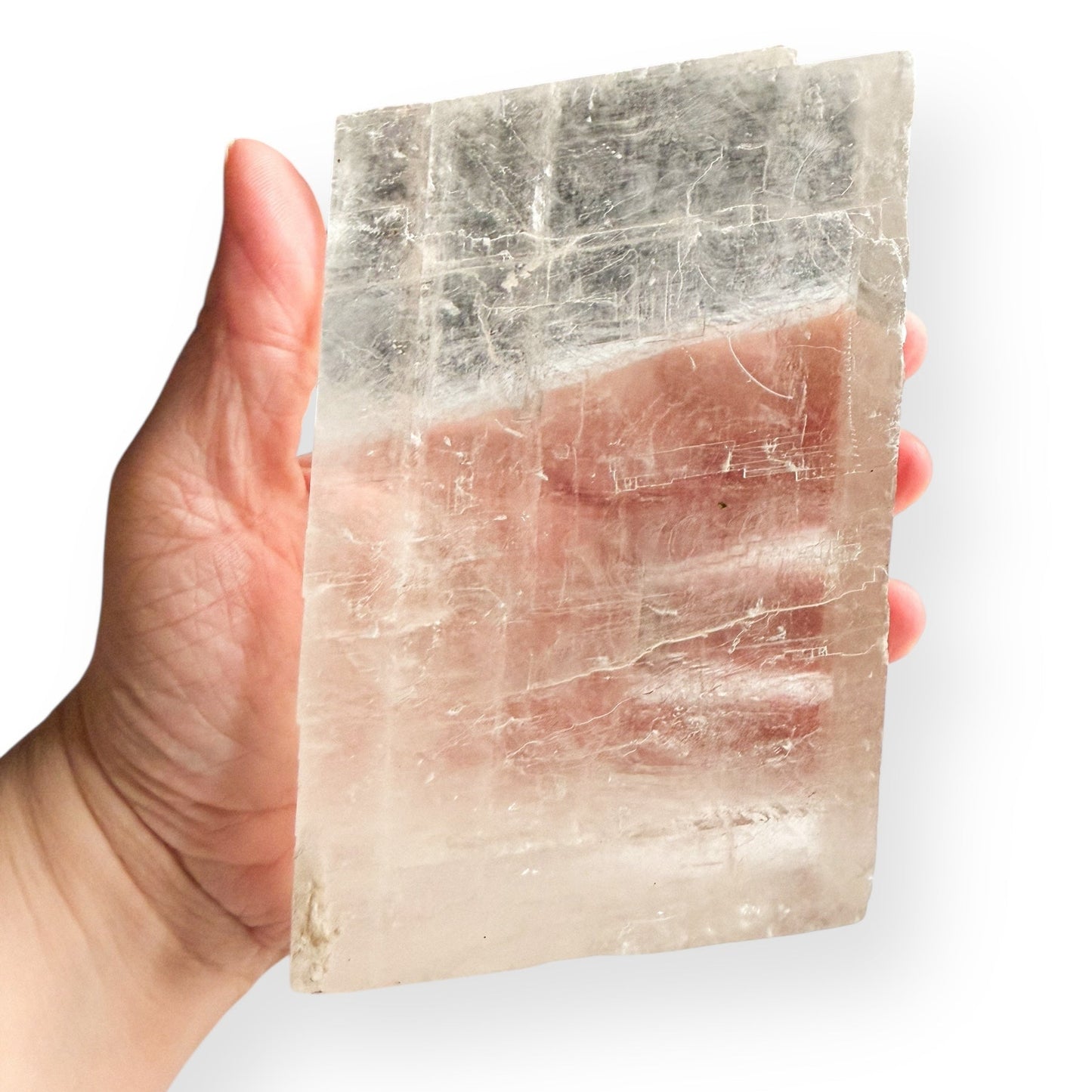 Optical Calcite slab shown in hand to display size and thickness