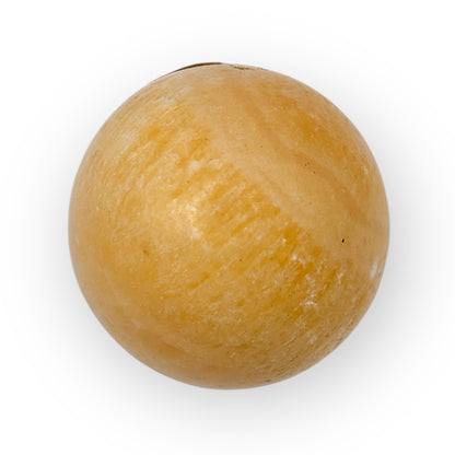 Close-up of Orange Calcite egg featuring soft polish, vibrant color, and creative energy