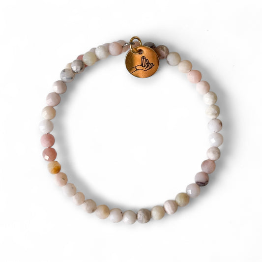 Pink Opal Wrap Bracelet with soft blush and peach beads on white background