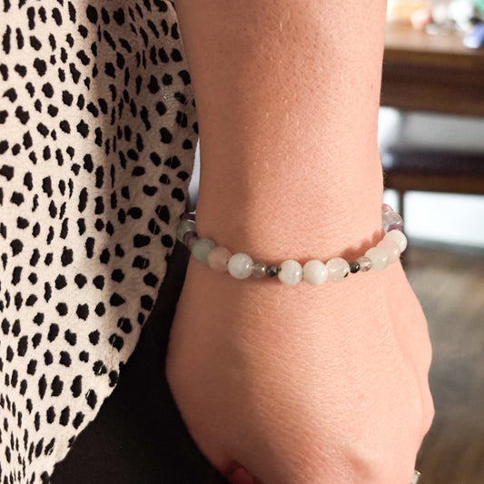 Pisces Crystal Charm Bracelet with a white charm worn on wrist, highlighting its comfortable, adjustable fit.