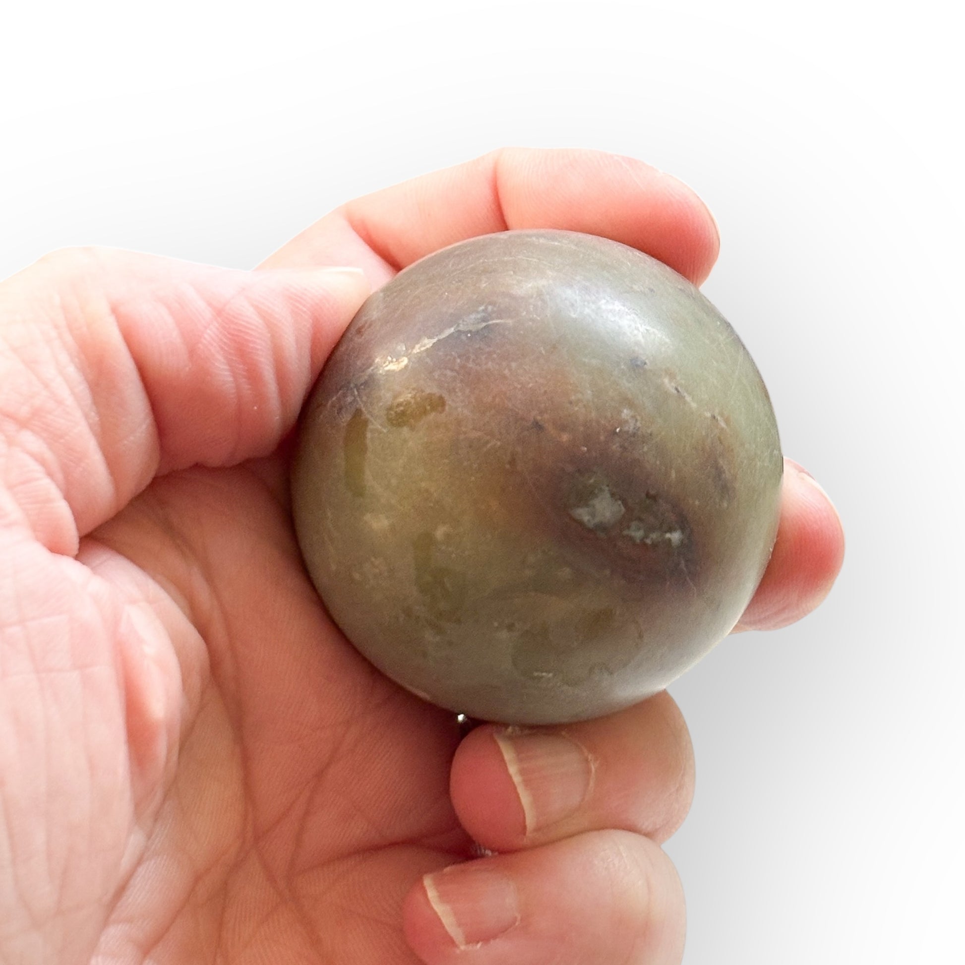 Matte Polychrome Jasper Sphere held in hand for size reference