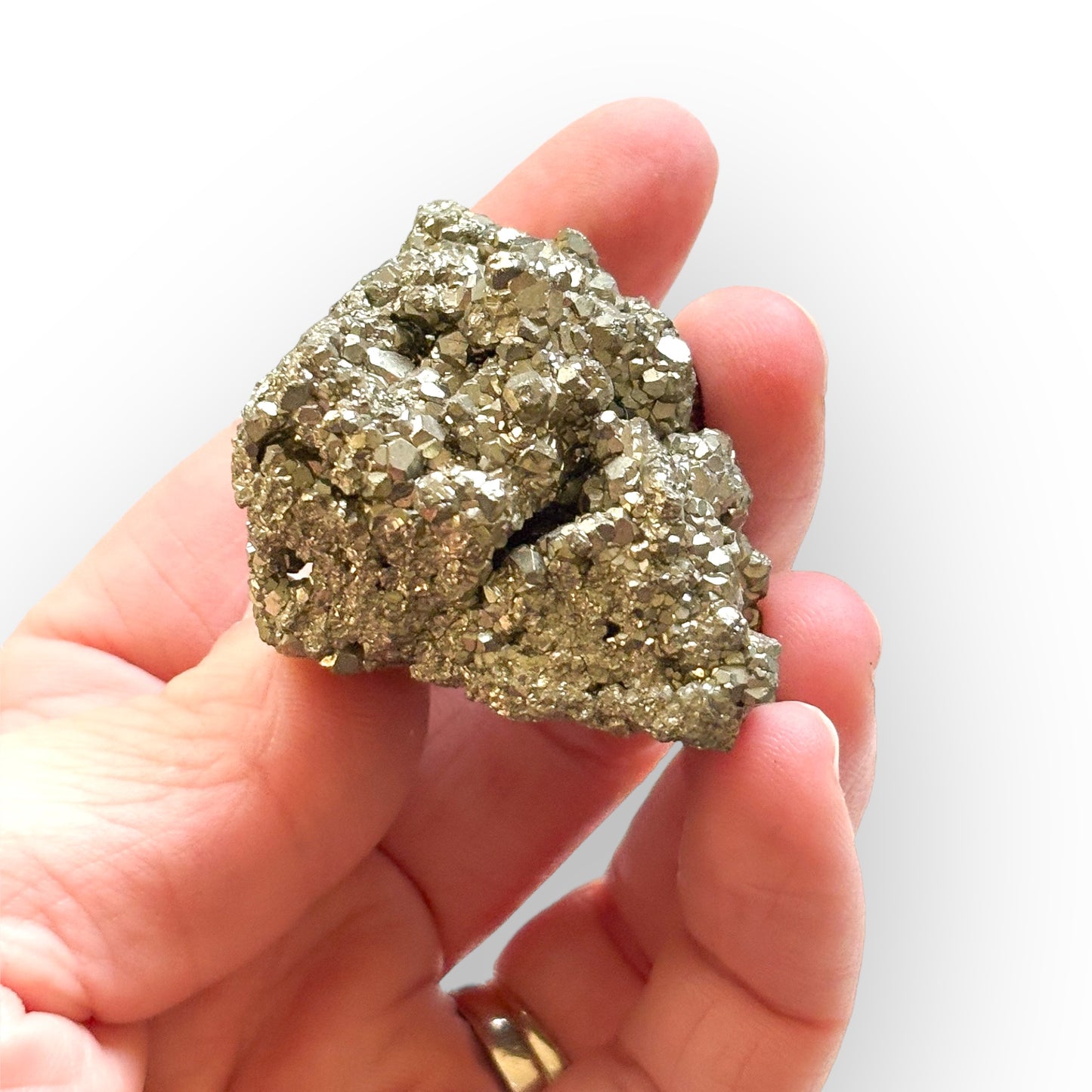 Pyrite Crystal Cluster held in hand, showing size and natural shine