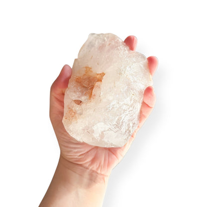 Hand holding Extra Large Clear Quartz Point to show size and light reflection