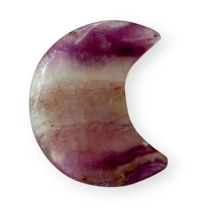 Hand-carved rainbow fluorite crescent moon featuring natural purple, white, and translucent banding.