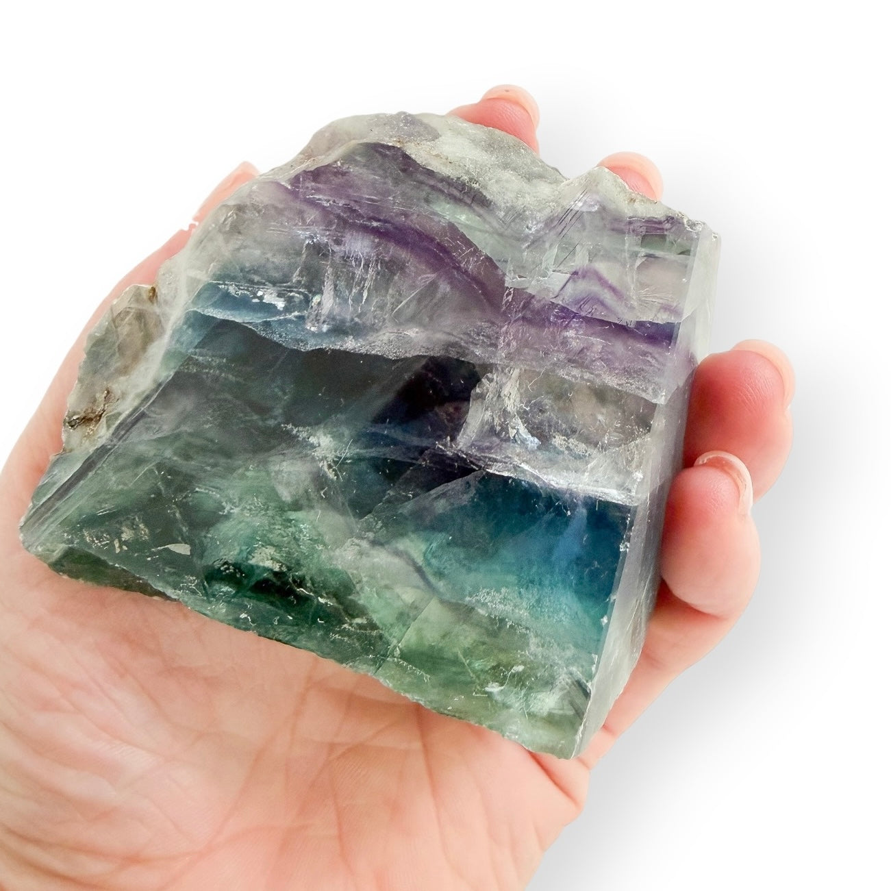 Rainbow Fluorite freeform held in hand for size reference, featuring polished and natural surfaces.