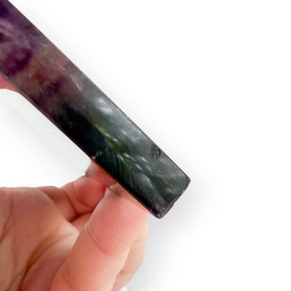 Side profile of a polished Rainbow Fluorite slab revealing natural color zoning and translucent layers.