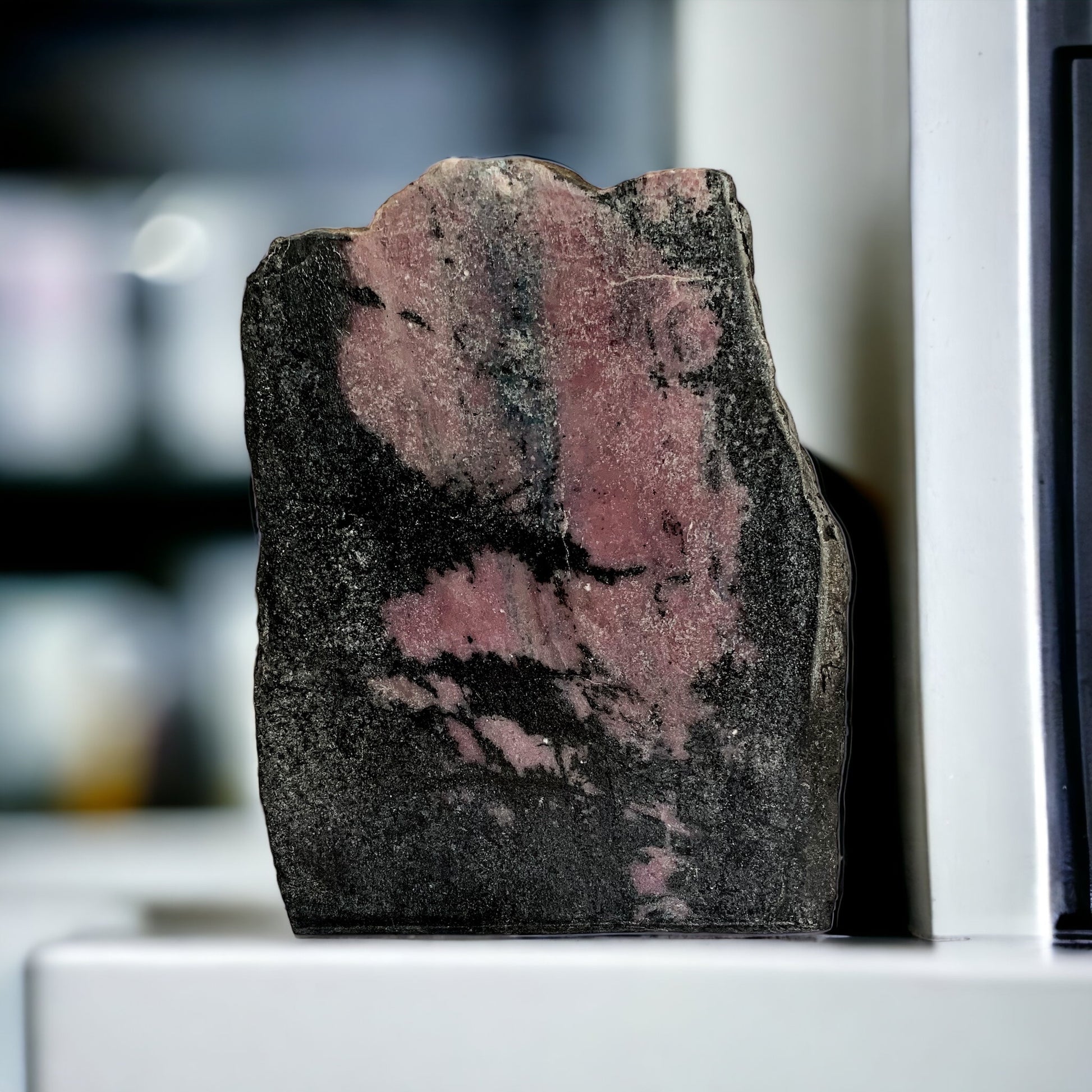 Upright Rhodonite Free Form crystal display piece with pink and black tones