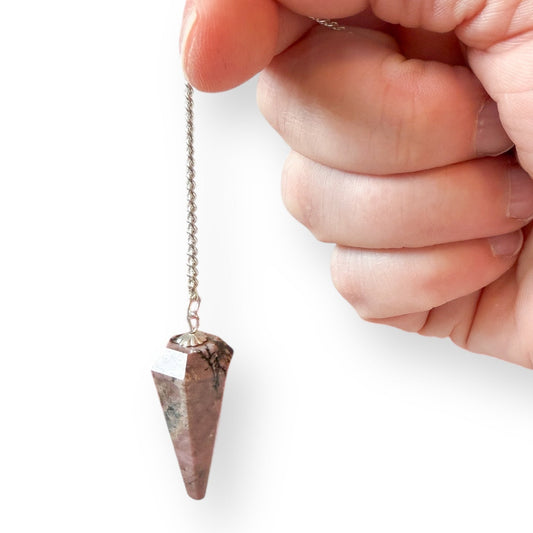 Rhodonite crystal pendulum held by chain showing size and polished finish