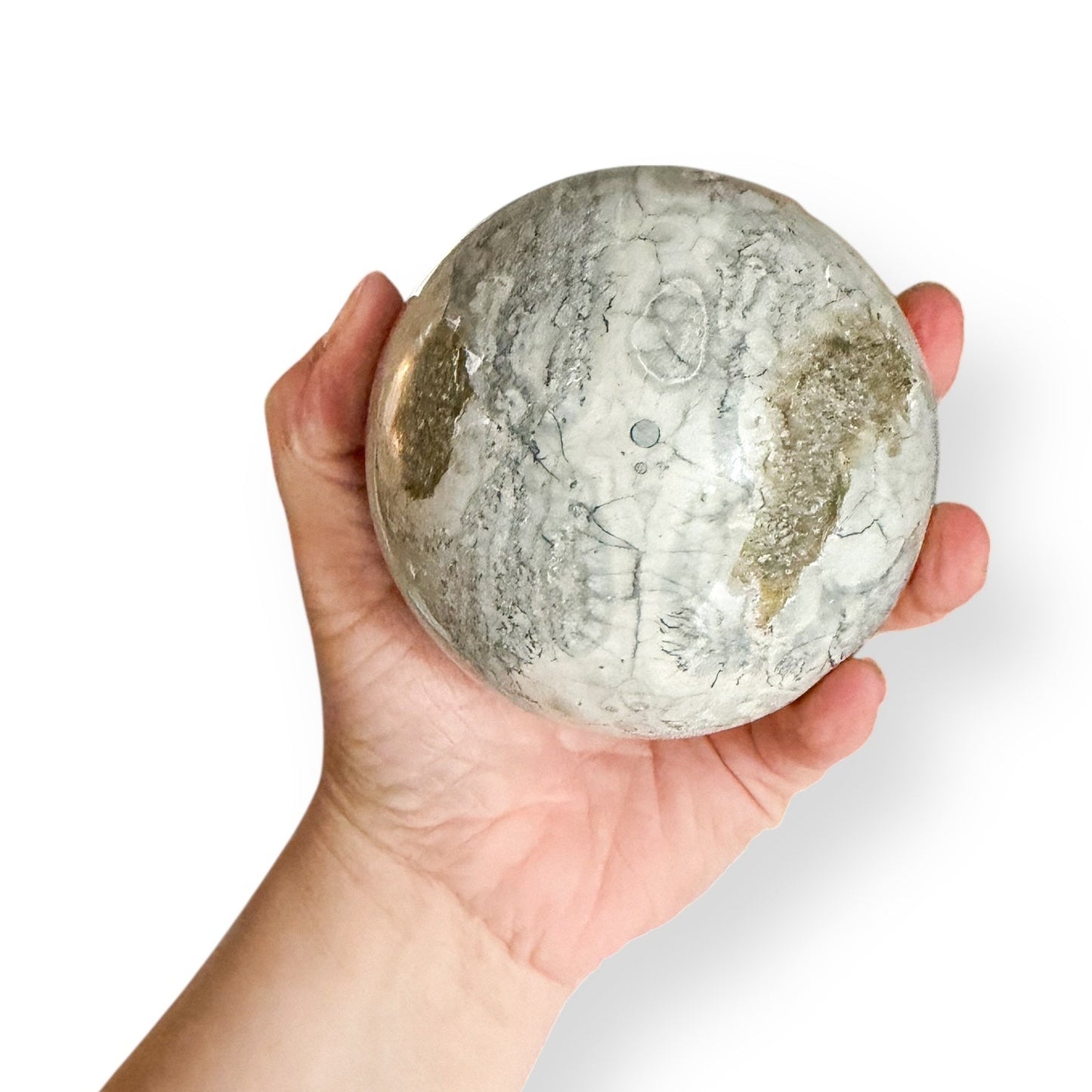 Close-up of rhyolite sphere texture showing orb-like pattern and polished surface
