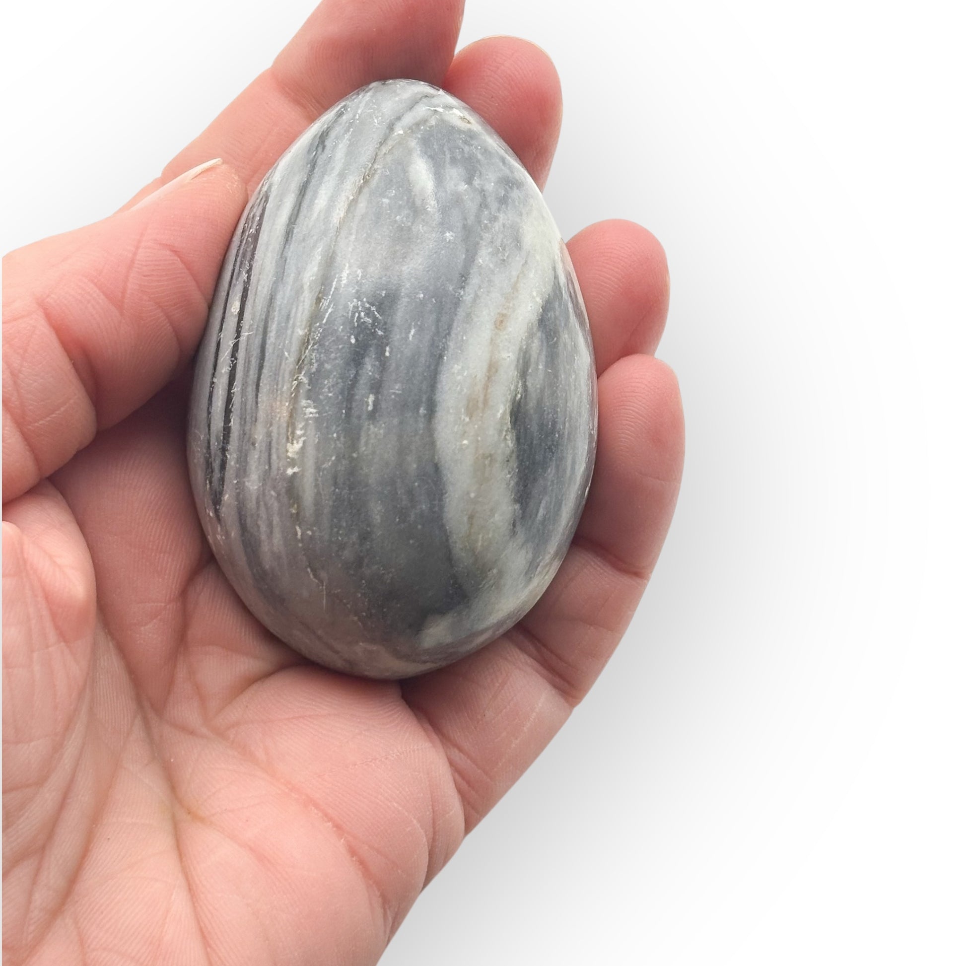 Close-up of Rhyolite egg showing smooth surface and detailed earthy stone patterns