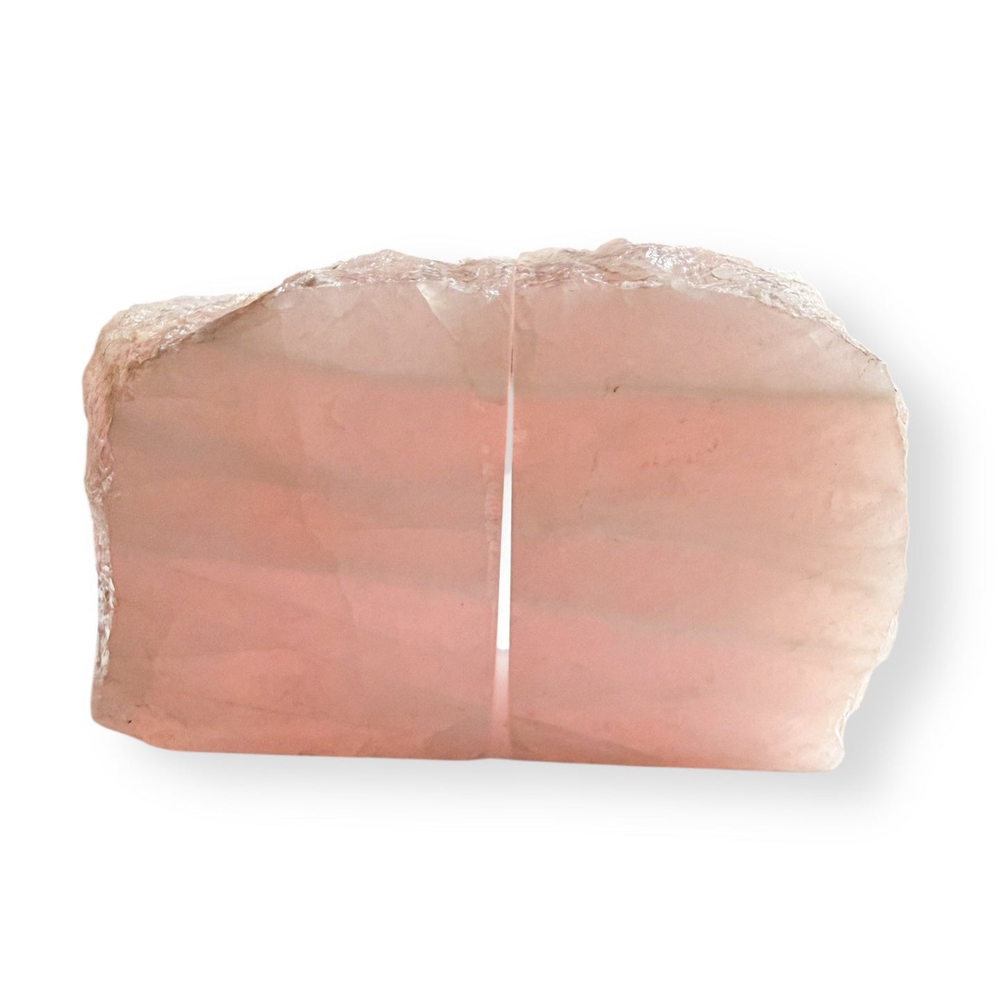 Close up detail of rose quartz bookends highlighting polished surface and natural inclusions.