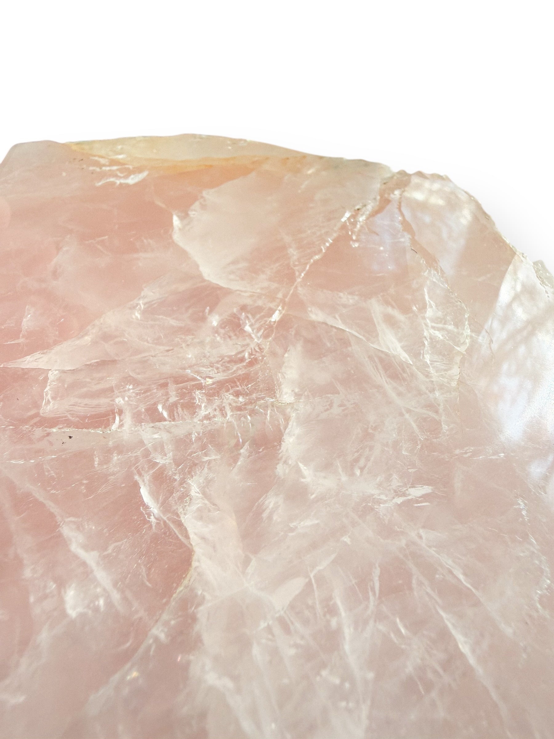 Close-up detail of Rose Quartz crystal texture with soft pink tones and natural veining.