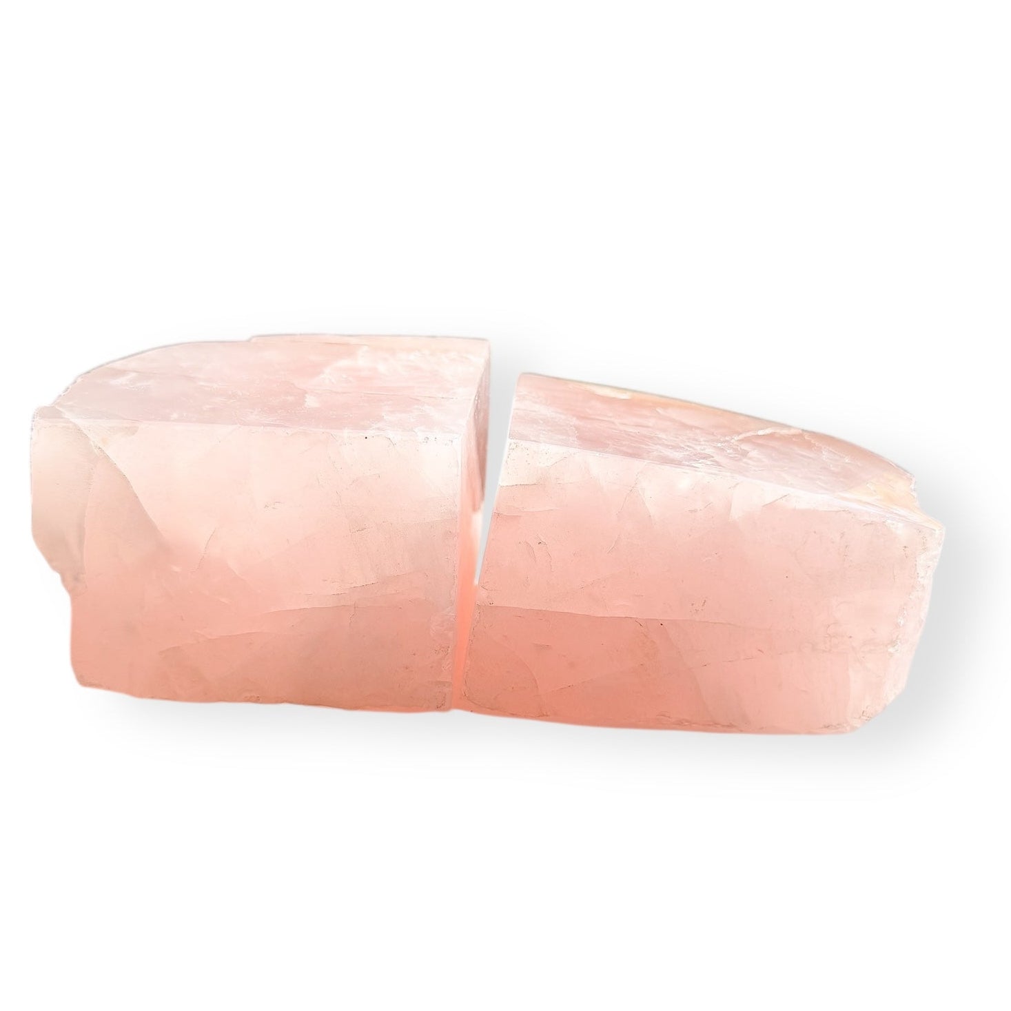 Matching pair of Rose Quartz bookends cut from the same stone, soft layered blush color.